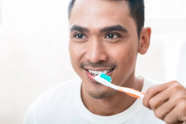 Hombre asiático cepillarse los dientes — Foto de Stock