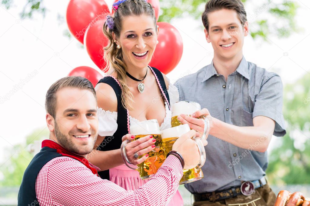 Three friends in Munich Beer garden clinking