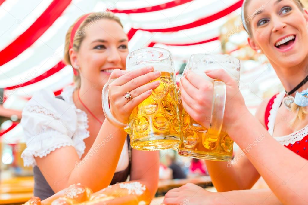 Friends drinking Bavarian beer at Oktoberfest 