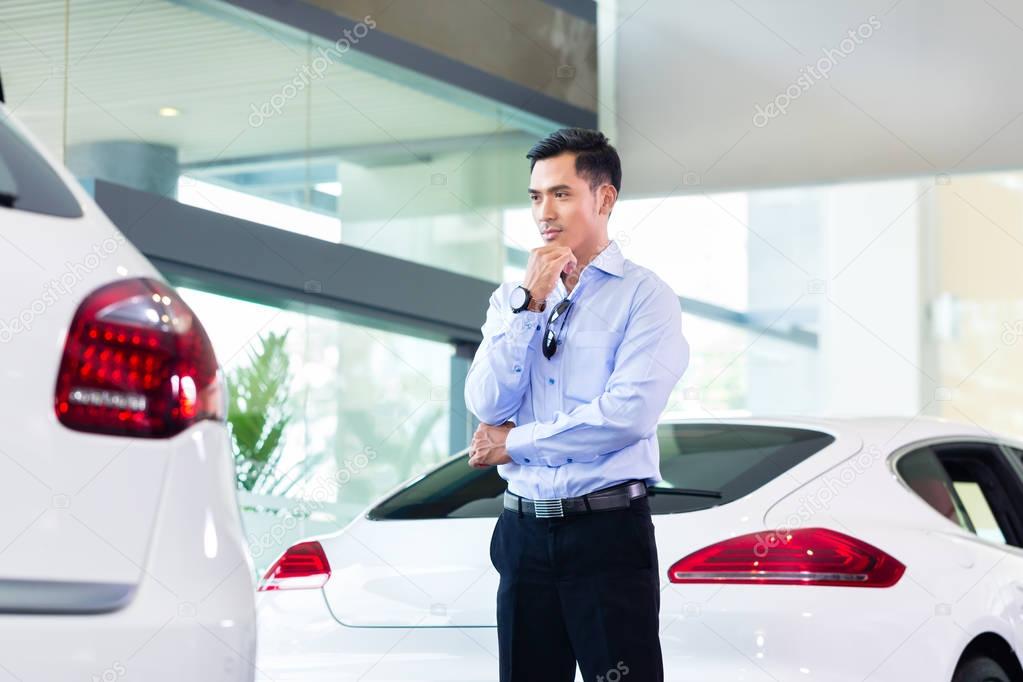 Asian man buying  car 