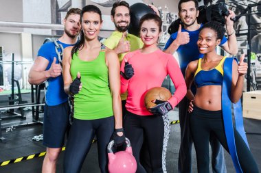 Group of women and men in gym  clipart