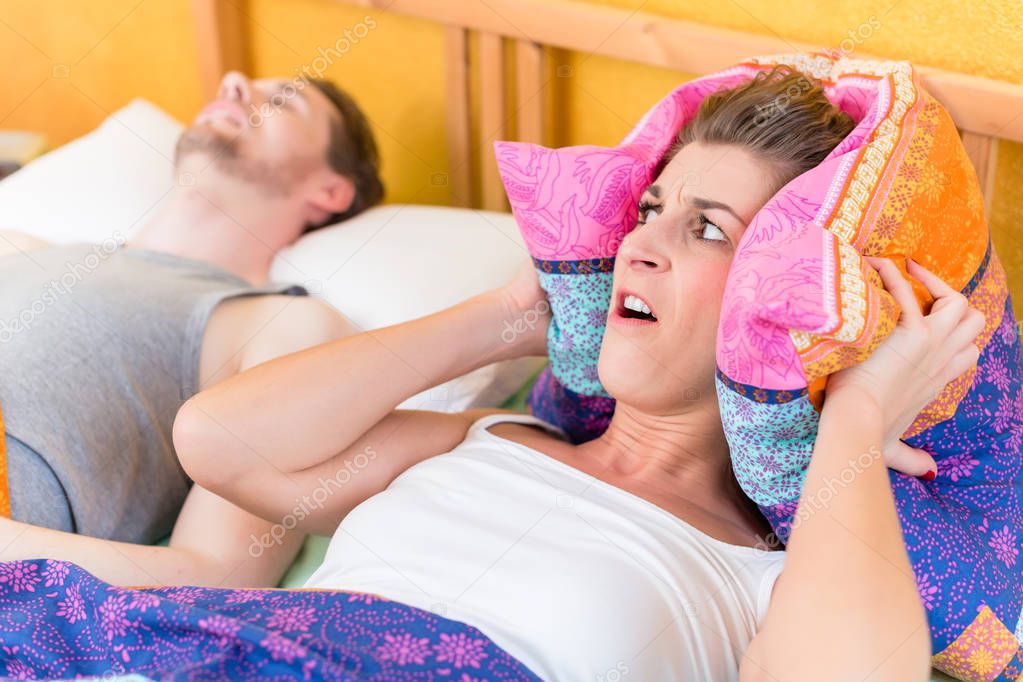 Woman is sleepless and angry because of her snoring husband