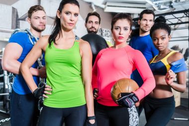 Group of women and men in gym   clipart