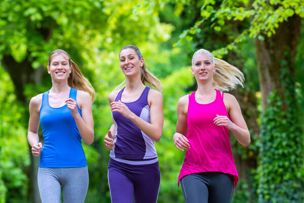 young women jogging in forest
