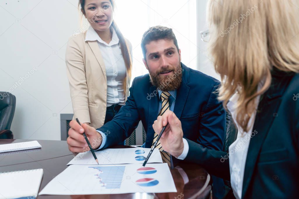 Business analyst with his female colleagues in office