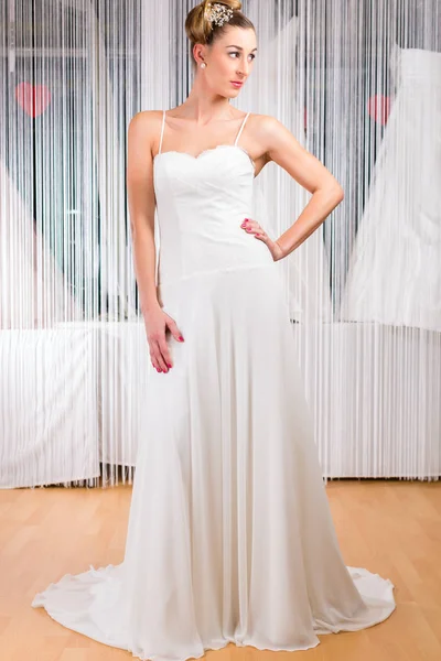 Woman trying wedding dress in shop — Stock Photo, Image