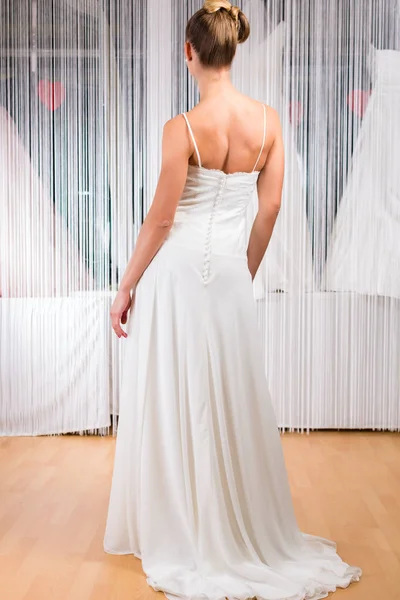 Woman trying wedding dress in shop — Stock Photo, Image