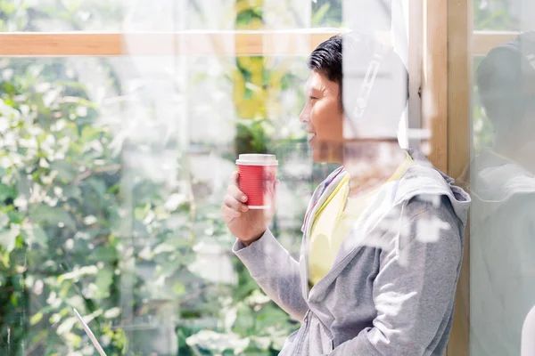 Young man day dreaming while drinking a coffee during break — Stock Photo, Image