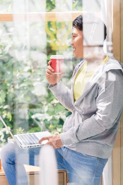 Ung man dag drömmer medan du dricker en kopp kaffe under paus — Stockfoto