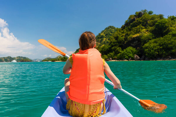 Rear view of young woman experiencing freedom during vacation in