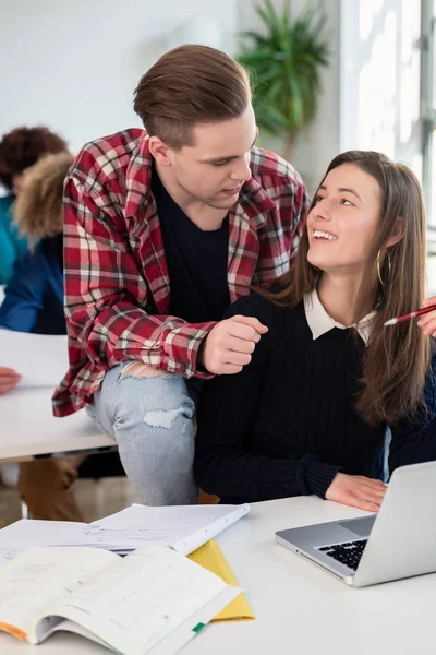 Dvě veselé tisícileté studenti smát spolu v sedle — Stock fotografie