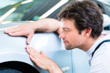 Male mechanic examine car  clipart