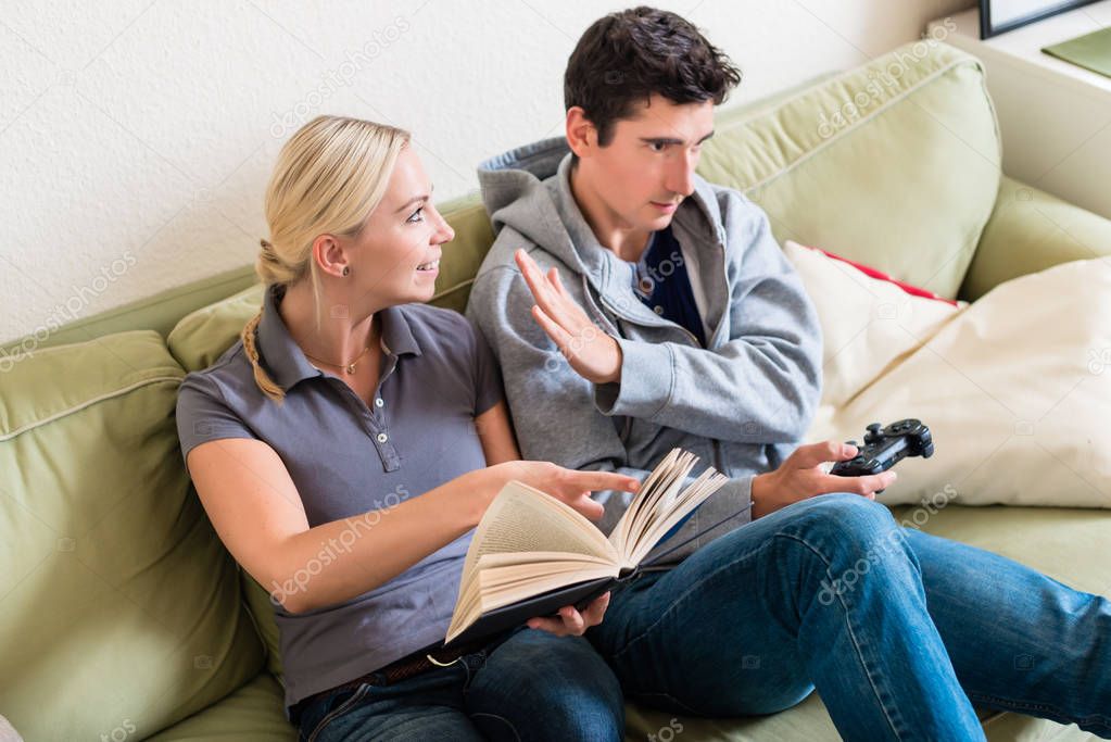 woman smiling next to boyfriend watching TV 