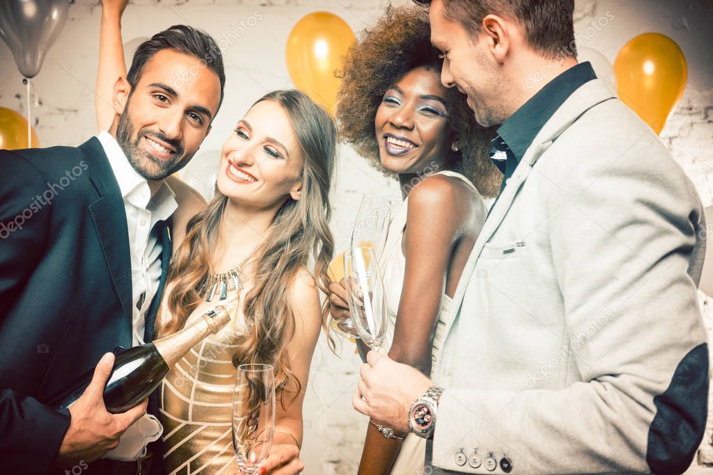 Group of women and men celebrating with champagne