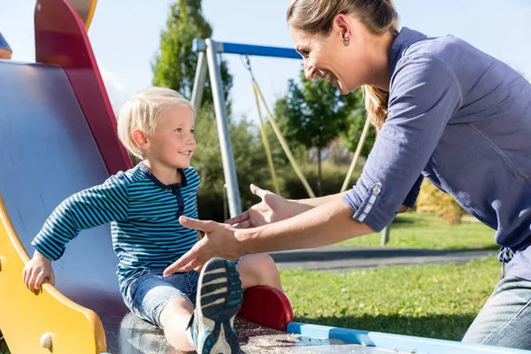 Little boy sliding down slide — Stock Photo, Image