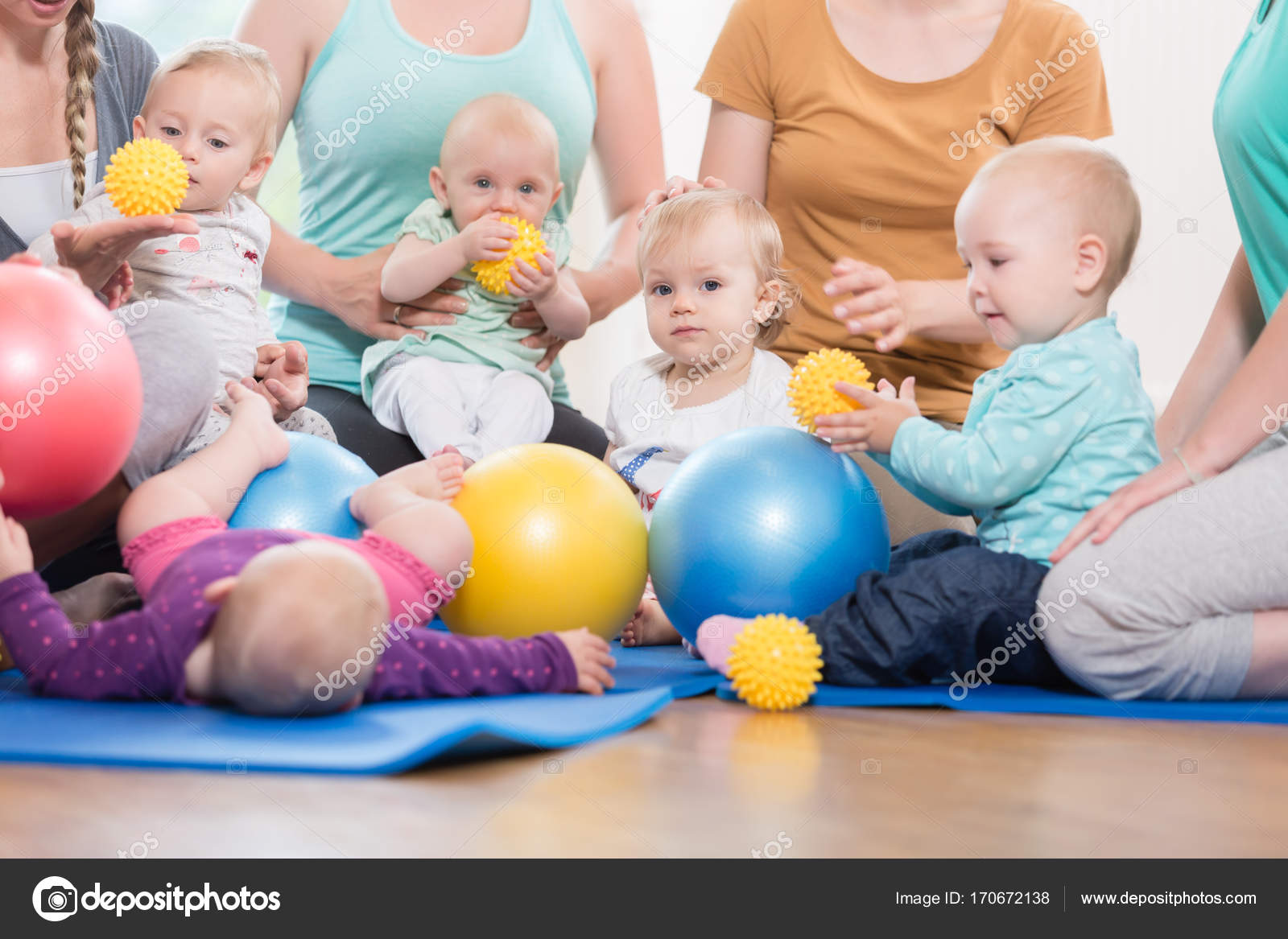 Young women in mother and child group playing with their baby ki stock photo