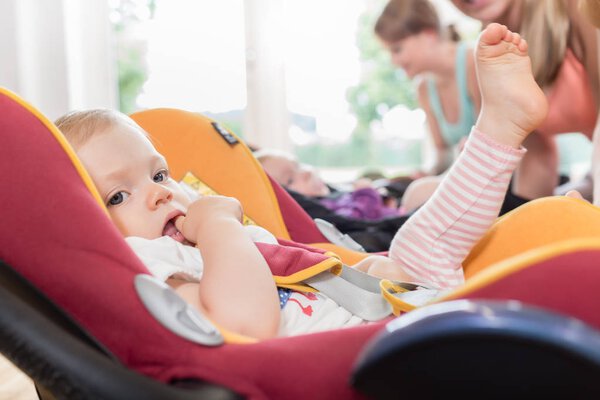 Мамы и младенцы на курсах матери и ребенка практикуются с младенцем
