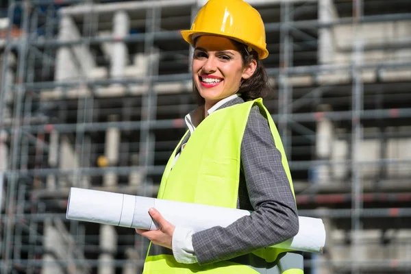 Female civil engineer with construction plans — Stock Photo, Image
