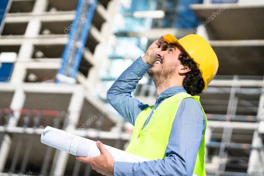 Construction engineer studying floor plan 