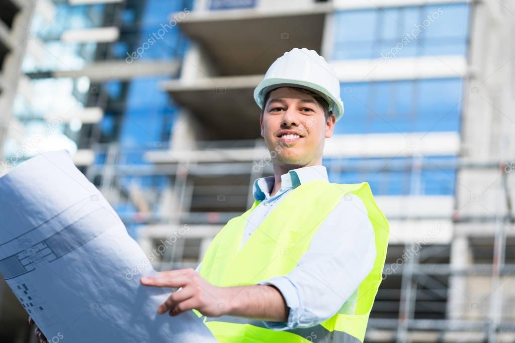 Construction engineer studying floor plan