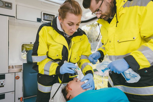Emergency medics performing reanimation on clinically dead woman