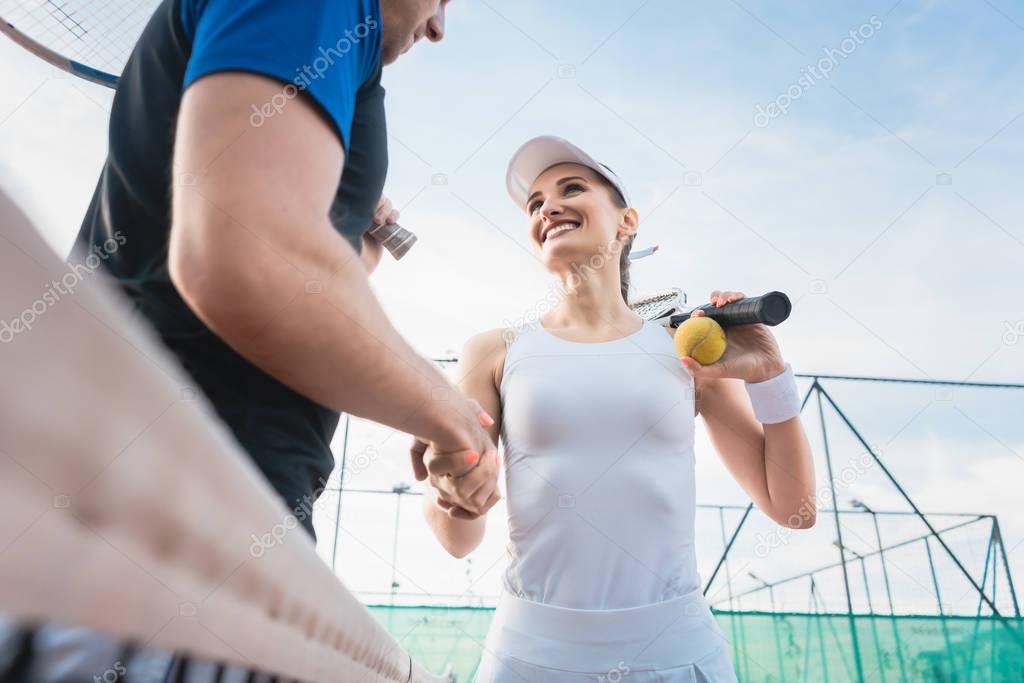 Tennis players shaking hand after match