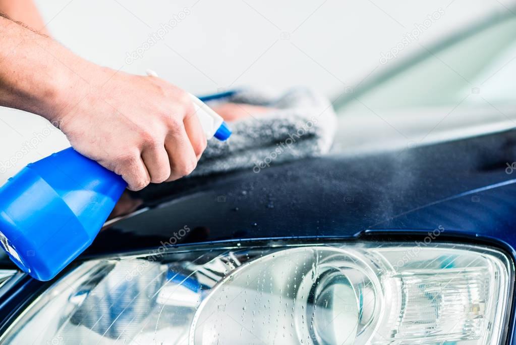 Male hands cleaning car