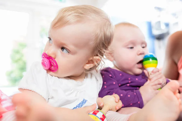Babies with pacifier in toddler group playing with toys — Stock Photo, Image