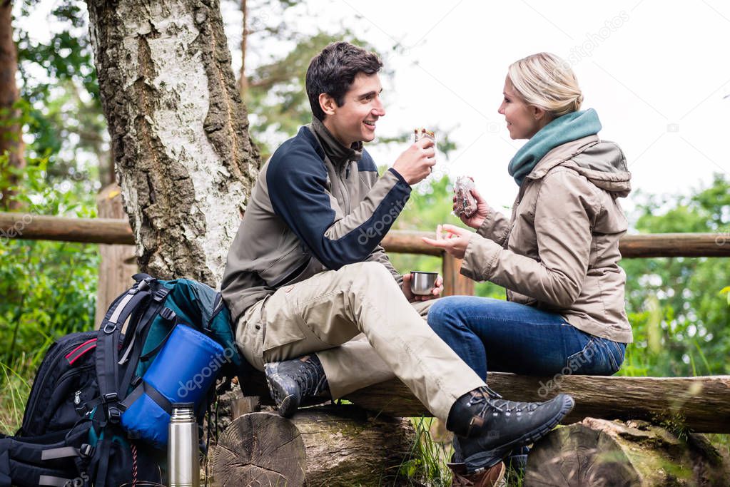 Backpacker couple taking rest aside hiking trail