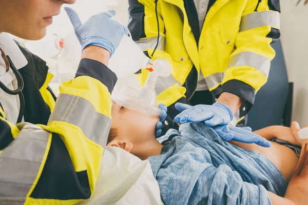 Emergency doctor giving cardiac massage for reanimation in ambul — Stock Photo, Image