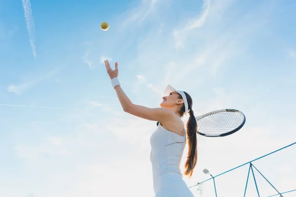 Mujer jugando tenis dando servicio — Foto de Stock
