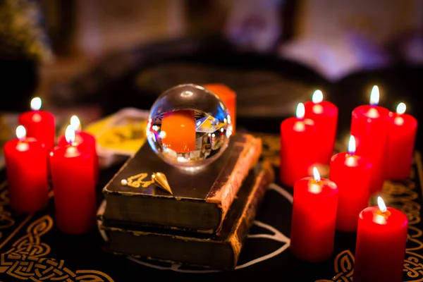 Crystal ball in the candle light to prophesy — Stock Photo, Image