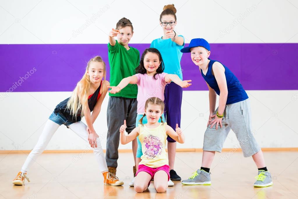 Kids train Zumba fitness in dancing school