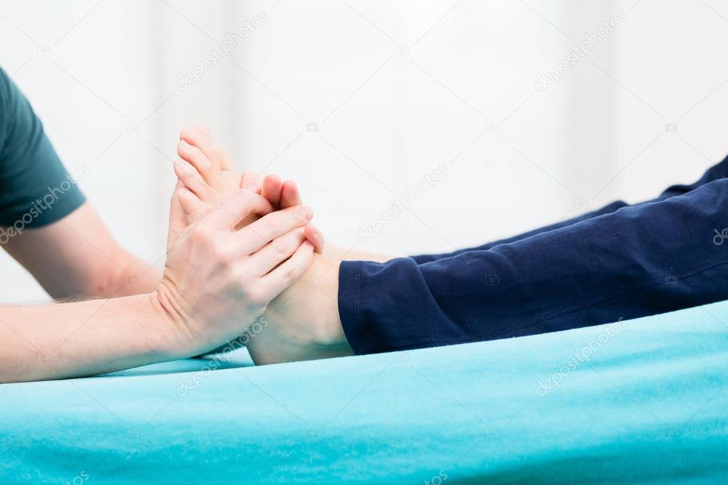 Patient having foot massage at physio