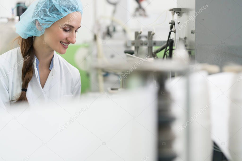 Happy woman employee working as manufacturing engineer in factor