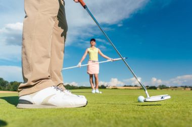 Yakın çekim yan görünüm erkek profesyonel golf oyuncu başlamak top atıcı kulübü ile zorlu bir oyun sırasında ortağıyla vurmaya