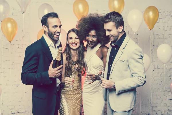 Man, on new year or birthday party opening bottle of champagne — Stock Photo, Image