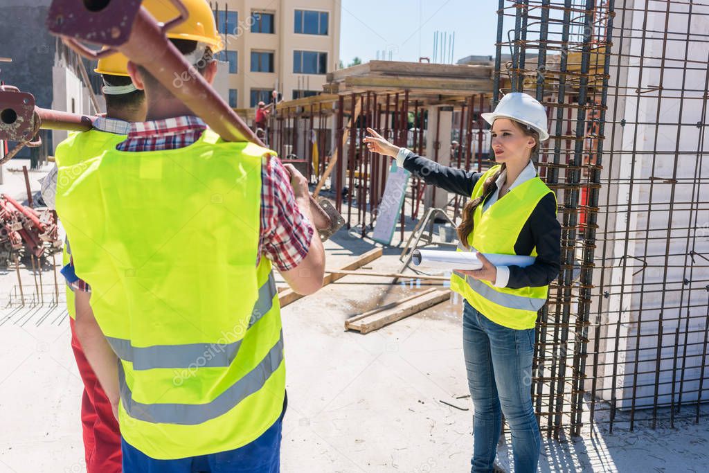 Experienced female foreman coordinating and guiding workers