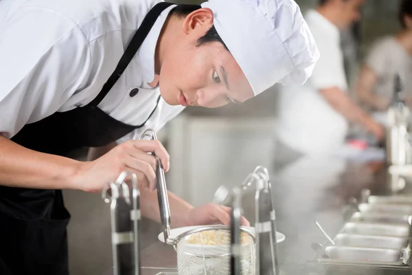 Young Asian Chef Plating Food Restaurant Carefully Pipetting Garnish Side — Stock Photo, Image
