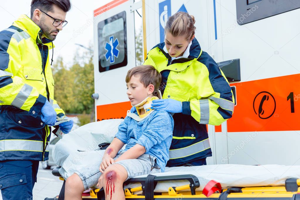 medics taking care of injured boy