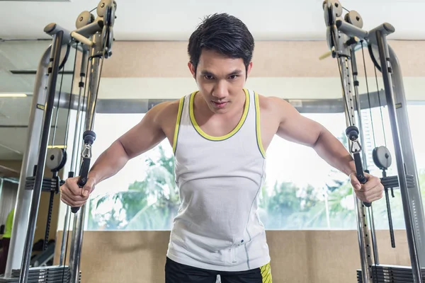 Asiático guapo hombre ejercitando cable crossover para pecho músculos — Foto de Stock