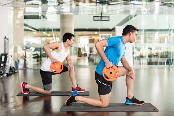 Determined young man exercising Russian twist