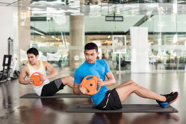 Determined young man exercising Russian twist — Stock Photo, Image