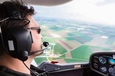 Sport Pilot flying his plane clipart