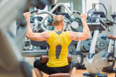 Güçlü kollarıyla egzersiz güçlü bir vücut geliştirmeci arka görünümü 