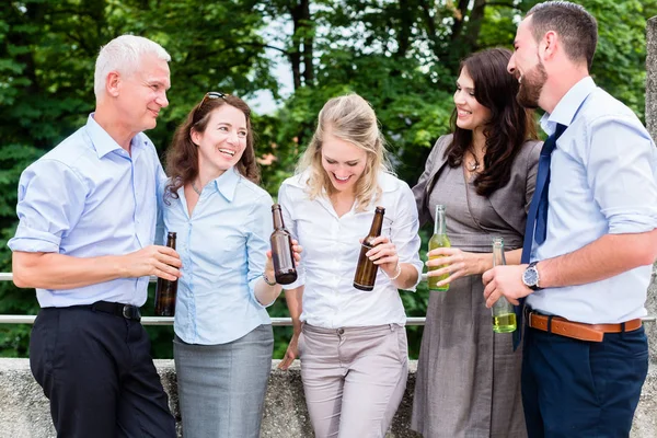 Office colleagues drinking beer after work