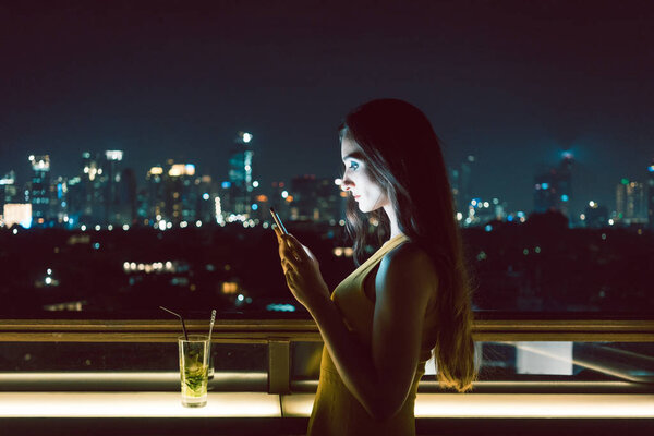 Woman receiving sad message on smart phone, her date does not show up
