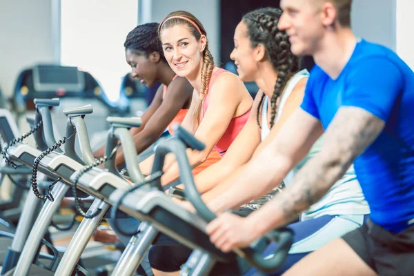 Brunette Beautiful Woman Smiling While Cycling Modern Fitness Bicycle Group — Stock Photo, Image