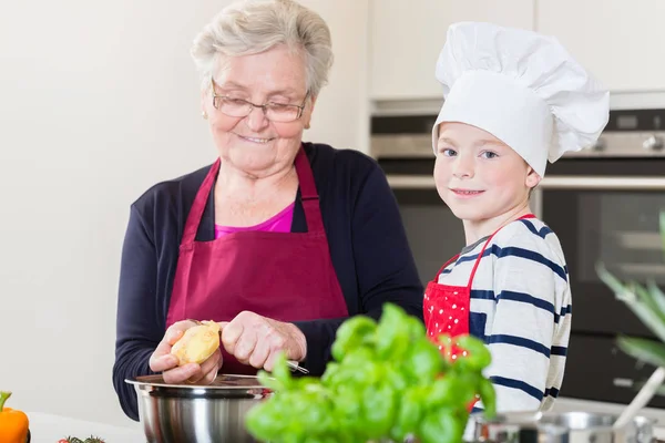 Happy grandma and grandson cooking together