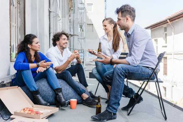 Team of Creative industries agency during lunch at office balcony